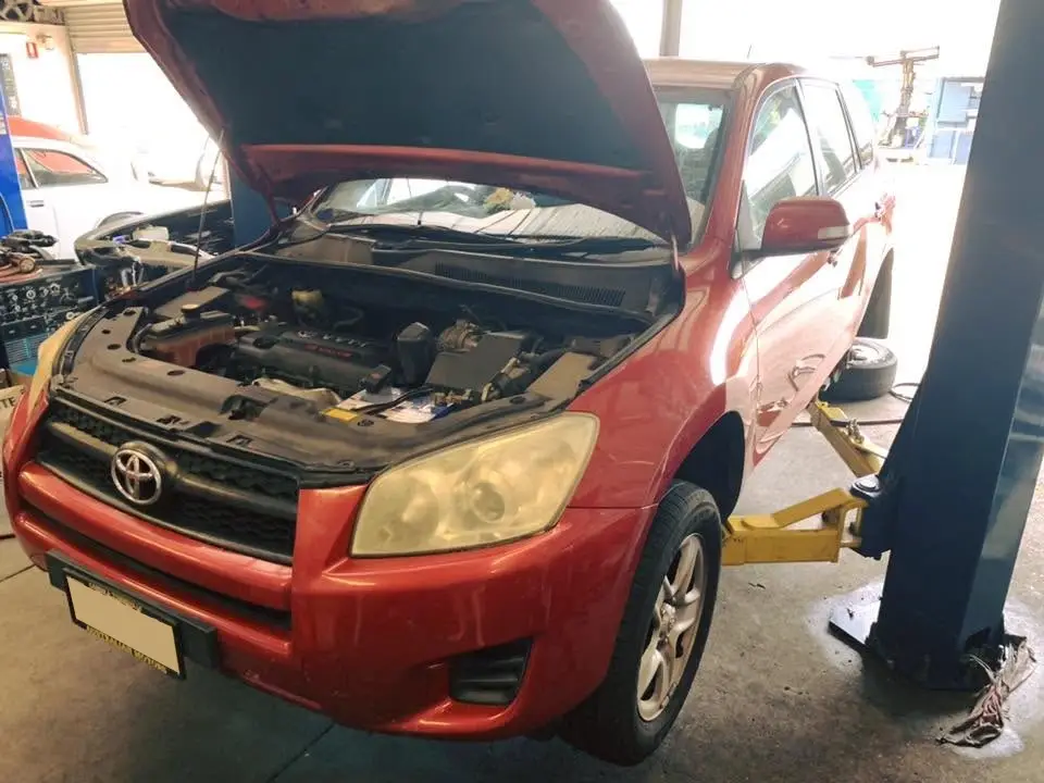 Toyota RAV4 with its bonnet raised during a service
