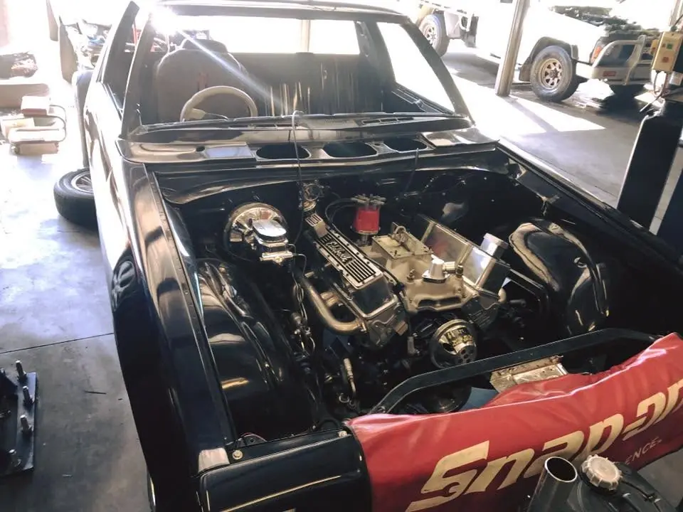 Engine bay open with diagnostic tools laid across the radiator support